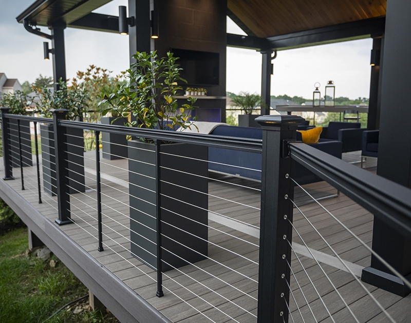 Covered deck with horizontal aluminum cable railing infill