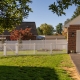 Backyard vinyl fencing next to a detached garage