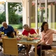 Family eating together at a table on a screened porch